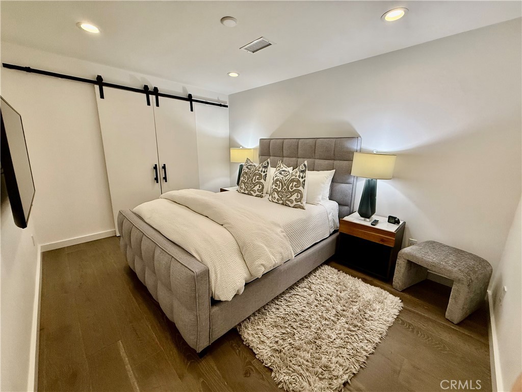 116 West Channel Islands Boulevard Oxnard, CA 93035 - Photo 45 of 60 a bedroom with a bed and a couch