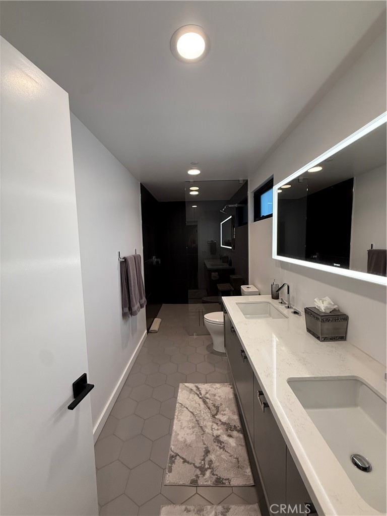 116 West Channel Islands Boulevard Oxnard, CA 93035 - Photo 47 of 60 a bathroom with a tub sink and mirror