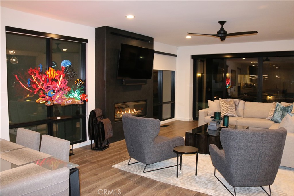 116 West Channel Islands Boulevard Oxnard, CA 93035 - Photo 6 of 60 a living room with furniture a flat screen tv and a fireplace