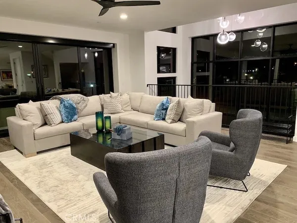 a living room with furniture and view of kitchen
