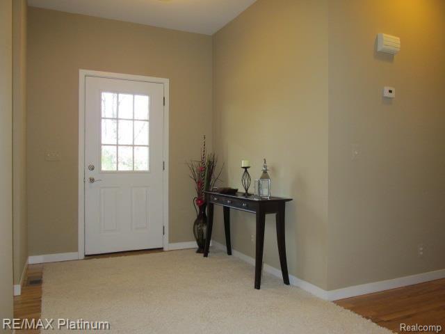 9094 Robb Road Fowlerville, MI 48836 - Photo 9 of 32 FOYER W/REFINISHED HARDWOOD FLOOR