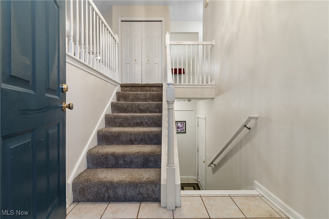1333 Derbydale Road Akron, OH 44306 - Photo 3 of 29 Front entrance leading up or downstairs, featuring tile patterned flooring and baseboards