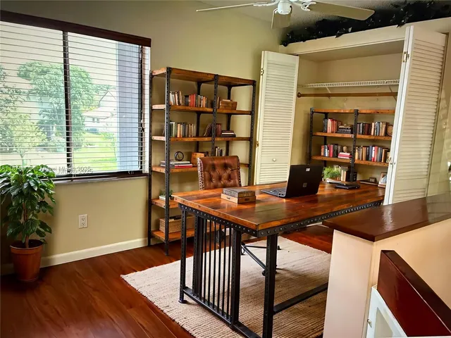 a view of a workspace with furniture and a potted plant
