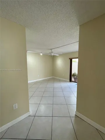 a view of a livingroom with wooden floor and a window