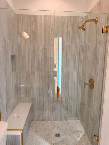 a view of an empty room with wooden floor and a cabinet