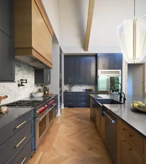 a kitchen with stainless steel appliances a sink a stove and a refrigerator