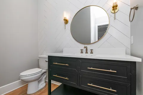 a bathroom with a toilet a sink and mirror