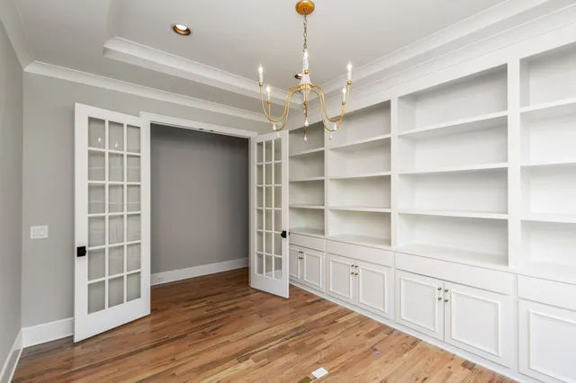 a view of a room with cabinets and wooden floor