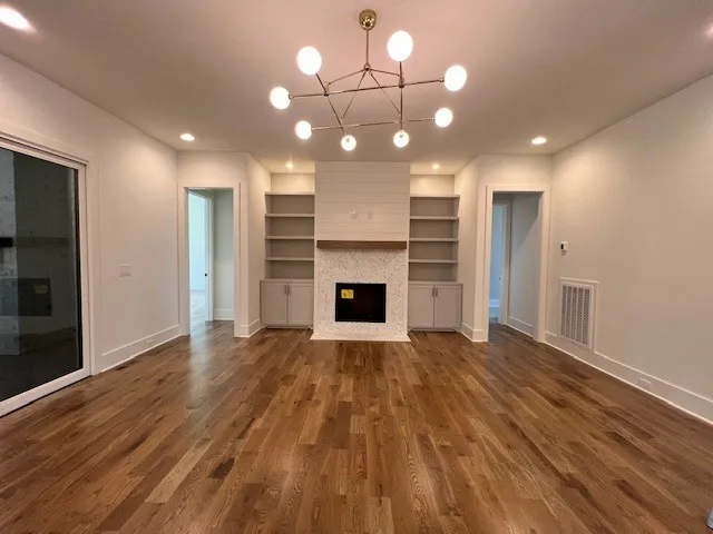 a view of a room with wooden floor and a fireplace