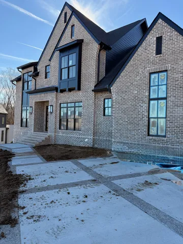 a view of a livingroom with a fireplace a chandelier and stairs