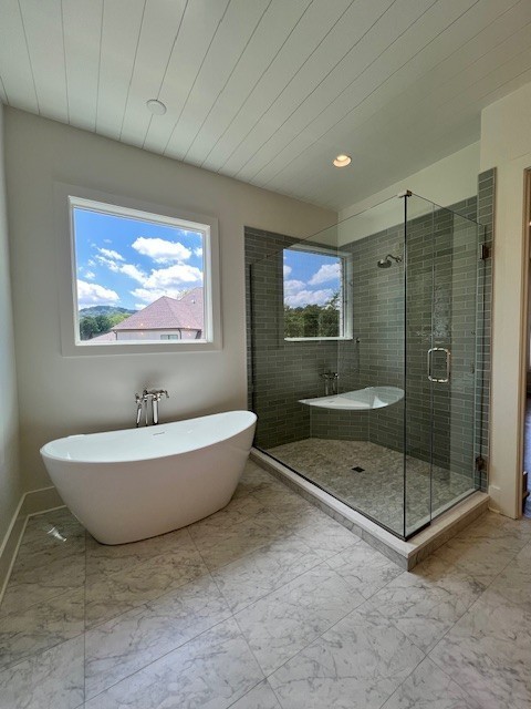 9493 Grand Haven Drive Brentwood, TN 37027 - Photo 32 of 37 a bathroom with a tub a toilet and a shower