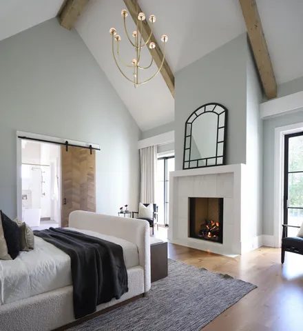 a bedroom with a bed and a fireplace