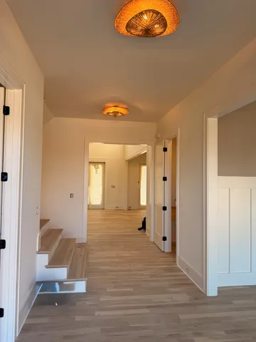 a living room with furniture a fireplace and a floor to ceiling window