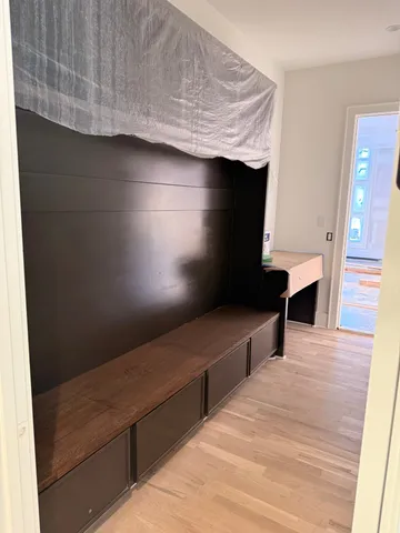 a bathroom with a granite countertop sink a toilet a mirror and a bathtub
