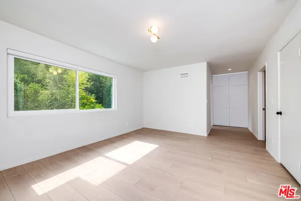 an empty room with large windows