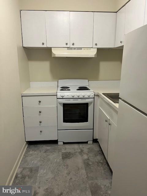 114 Park Avenue, Unit 5B Swarthmore, PA 19081 - Photo 5 of 9 a kitchen with granite countertop white cabinets and white stove