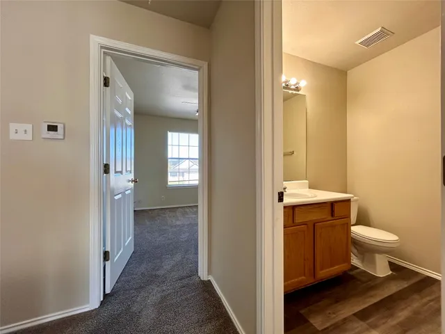 an empty room with a chandelier fan