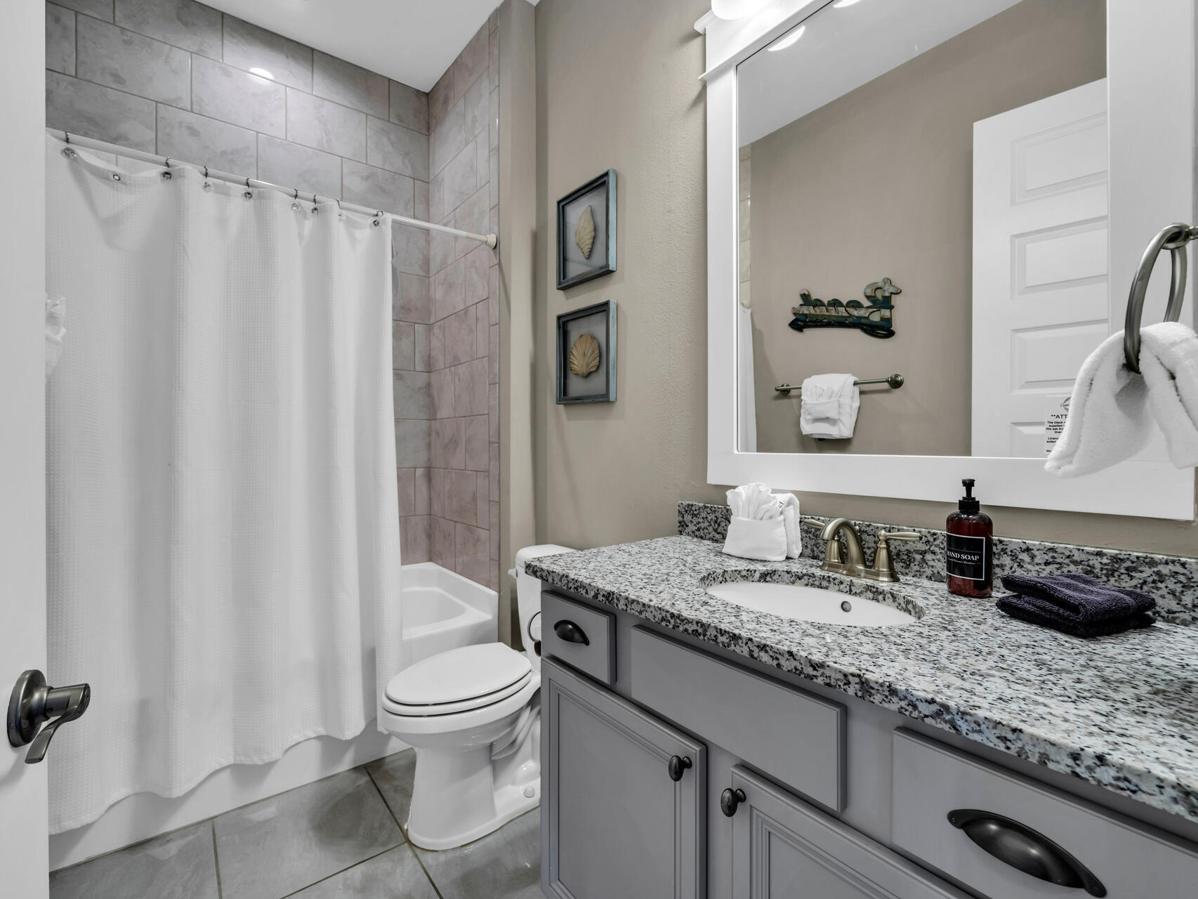79 Milestone Dr Inlet Beach, Unit C Inlet Beach, FL 32461 - Photo 20 of 56 a bathroom with a granite countertop sink a toilet and a mirror