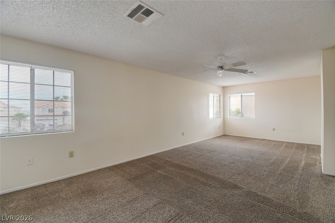 5 Tarryall Terrace Henderson, NV 89074 - Photo 32 of 44 A spacious room offers ample natural light and plush carpeting throughout.