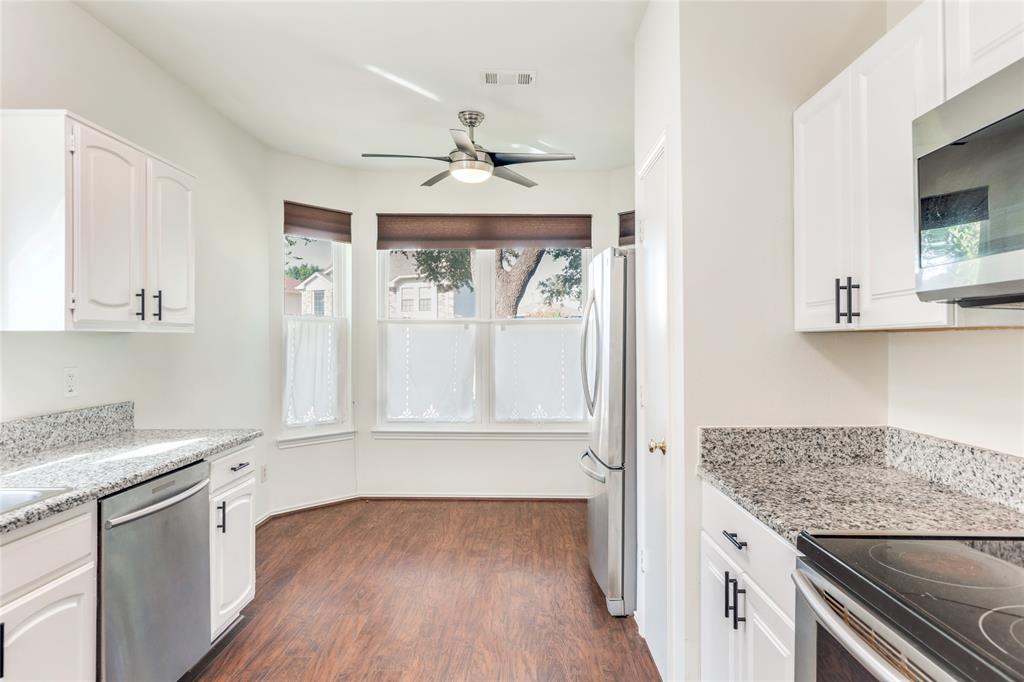 2151 Falcon Ridge Drive Carrollton, TX 75010 - Photo 16 of 40 a kitchen with granite countertop a sink cabinets stainless steel appliances and a counter space