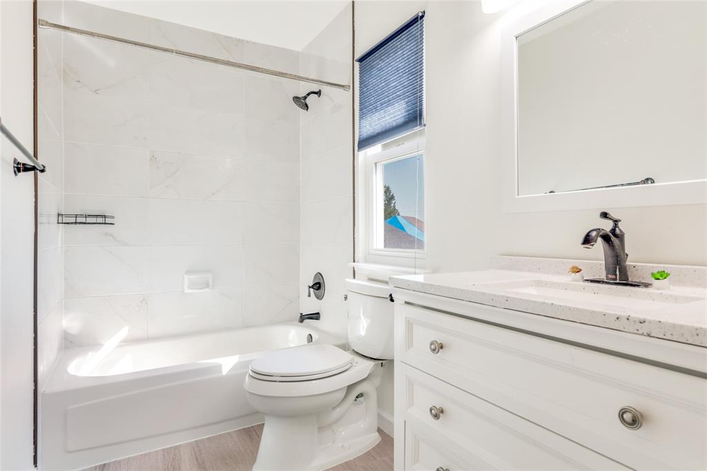 2151 Falcon Ridge Drive Carrollton, TX 75010 - Photo 31 of 40 a bathroom with a sink a toilet and shower