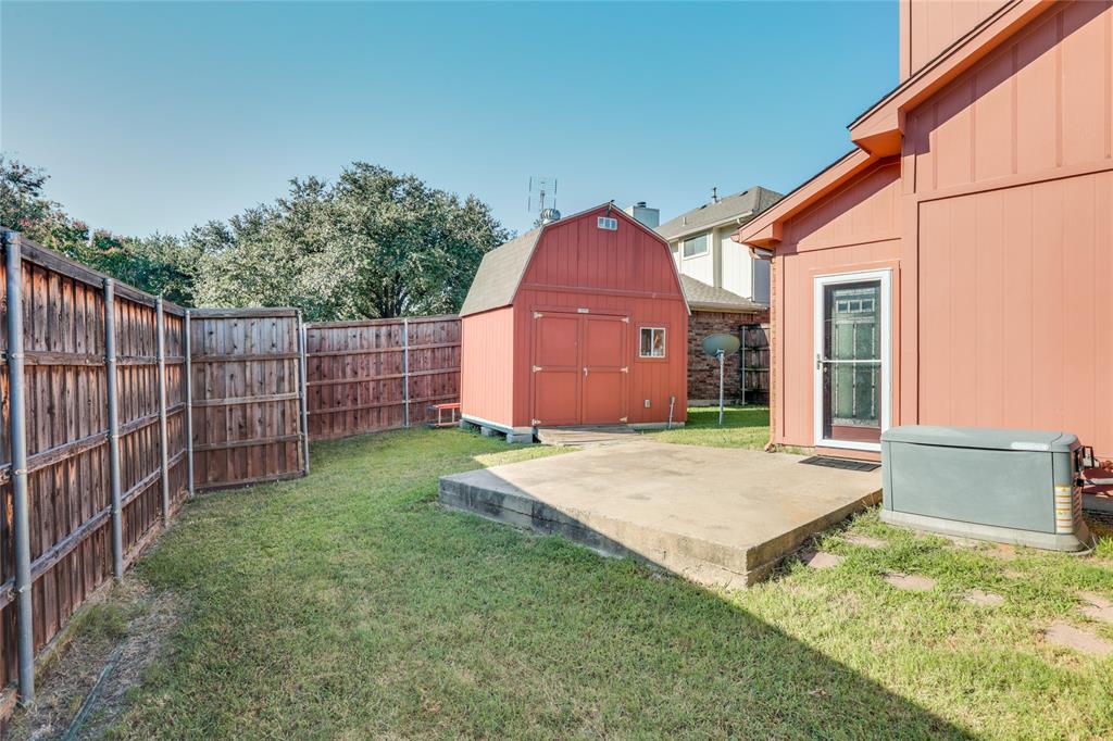 2151 Falcon Ridge Drive Carrollton, TX 75010 - Photo 32 of 40 a backyard of a house with wooden fence