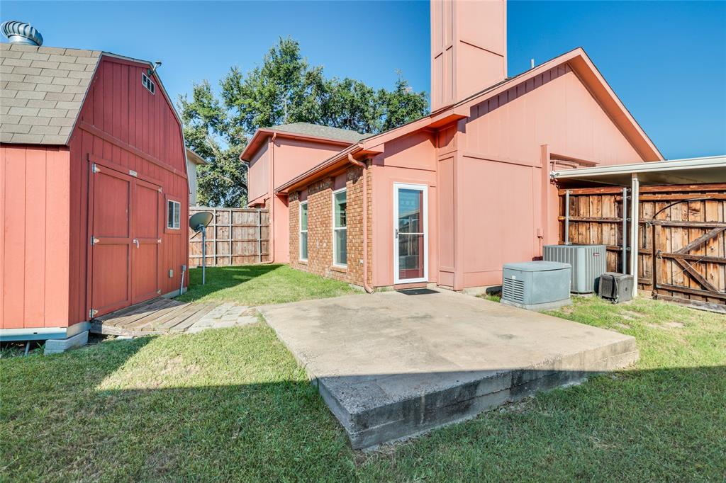2151 Falcon Ridge Drive Carrollton, TX 75010 - Photo 33 of 40 a view of a house with backyard and porch