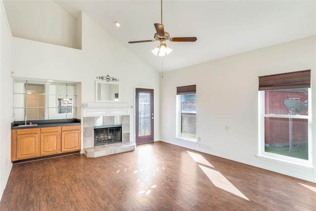 2151 Falcon Ridge Drive Carrollton, TX 75010 - Photo 8 of 40 a living room with stainless steel appliances granite countertop a fireplace
