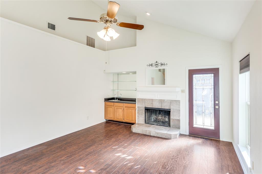 2151 Falcon Ridge Drive Carrollton, TX 75010 - Photo 10 of 40 a view of an empty room with wooden floor fireplace and a window