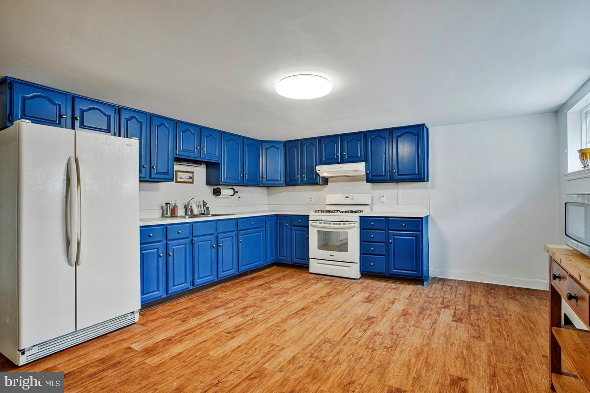 3040 Federal Street Baltimore, MD 21213 - Photo 26 of 41 a kitchen with stainless steel appliances a refrigerator and a sink