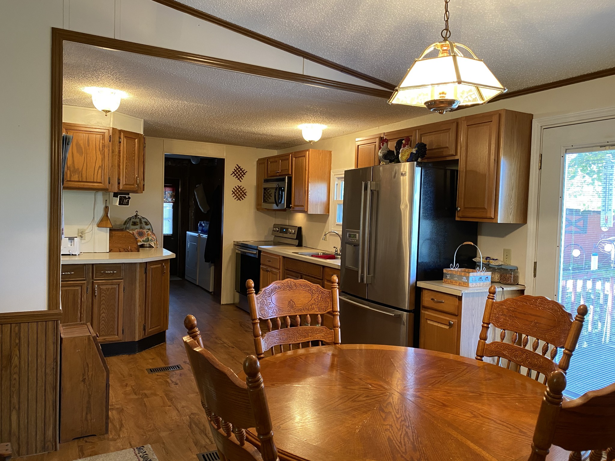4008 Green Road Springfield, TN 37172 - Photo 11 of 24 a kitchen with refrigerator a stove a sink and chairs