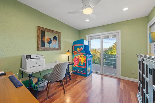 a kitchen with stainless steel appliances granite countertop a stove top oven a sink dishwasher and white cabinets with wooden floor