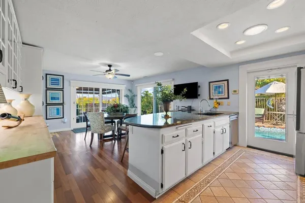 a kitchen with stainless steel appliances granite countertop a refrigerator and a sink