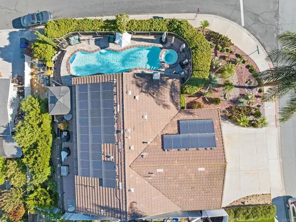 an aerial view of a house with outdoor space and a swimming pool