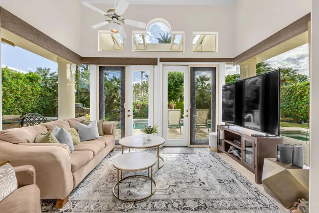a bedroom with a bed and a flat tv screen on dresser