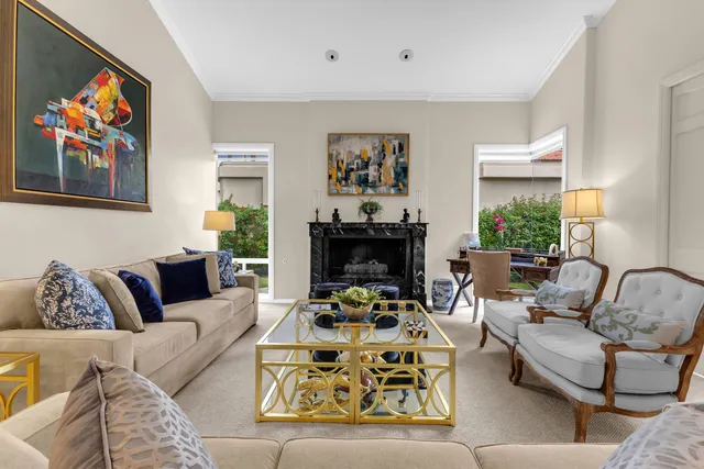 a kitchen with stainless steel appliances granite countertop a table chairs stove and cabinets