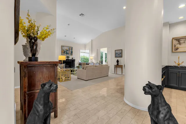 a kitchen with granite countertop a sink and white cabinets
