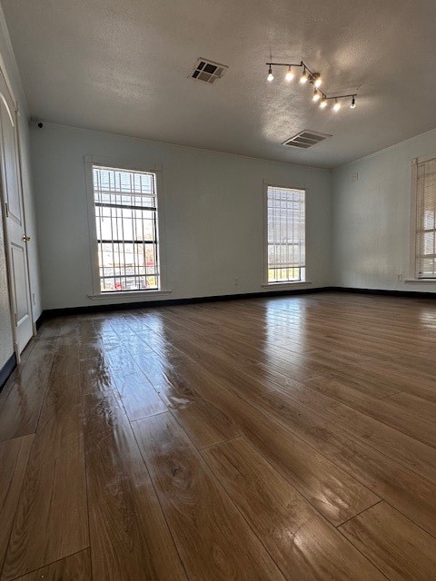 1326 Almeda Genoa Road Houston, TX 77047 - Photo 17 of 24 an empty room with wooden floor and windows
