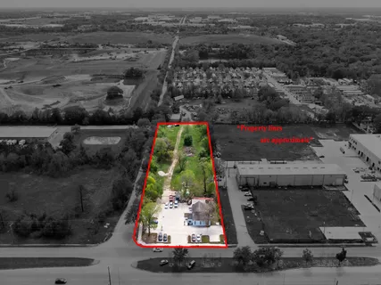 an aerial view of a house with a yard and lake view