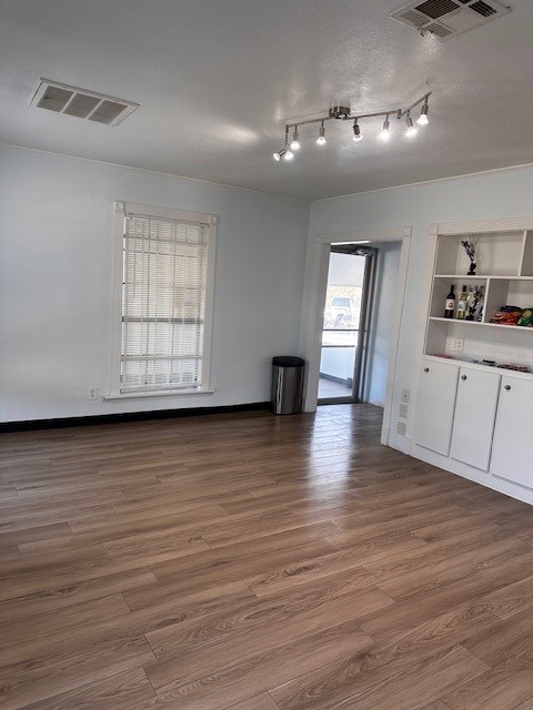 1326 Almeda Genoa Road Houston, TX 77047 - Photo 21 of 24 a view of an empty room with wooden floor and a window