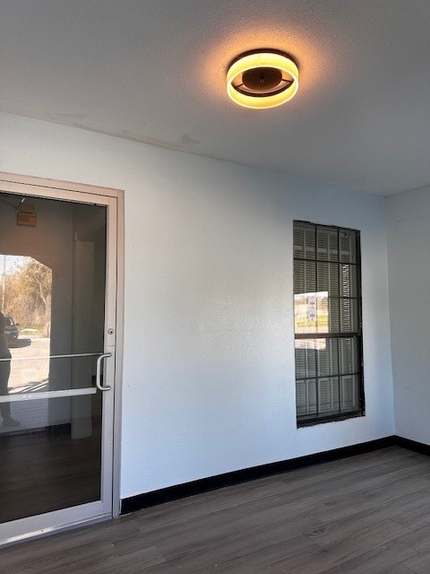 1326 Almeda Genoa Road Houston, TX 77047 - Photo 23 of 24 a view of an empty room with wooden floor and a window