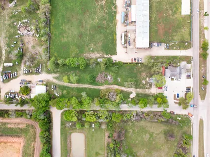 an aerial view of a house with garden space and lake view