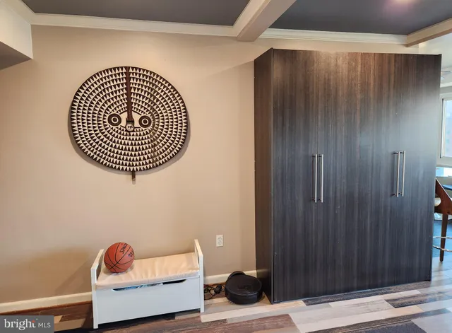 a living room with a wooden floor and a window