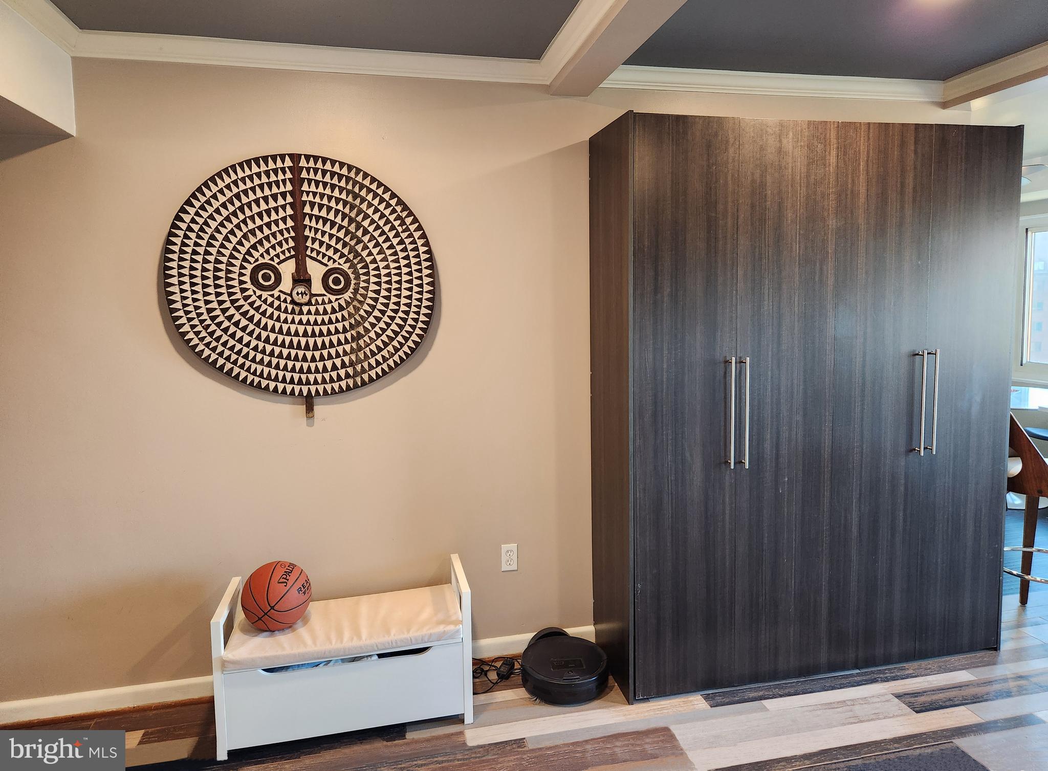 4201 Cathedral Avenue Northwest, Unit 1418E Washington, DC 20016 - Photo 12 of 17 a living room with a wooden floor and a window