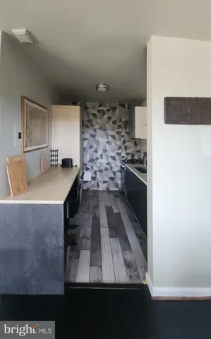 a kitchen with stainless steel appliances a stove a sink and a refrigerator