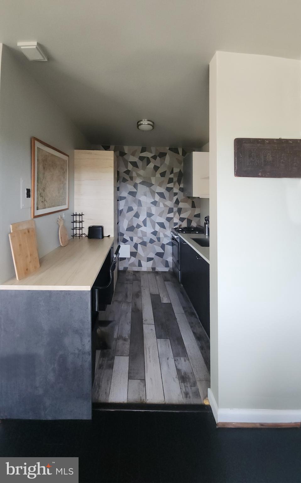4201 Cathedral Avenue Northwest, Unit 1418E Washington, DC 20016 - Photo 4 of 17 a kitchen with stainless steel appliances a stove a sink and a refrigerator