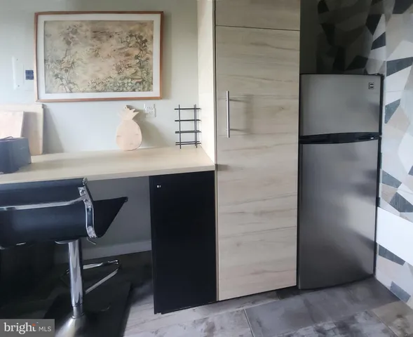 a bathroom with a sink and a refrigerator