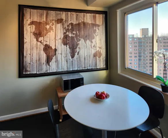 a view of a dining room with furniture and a large window