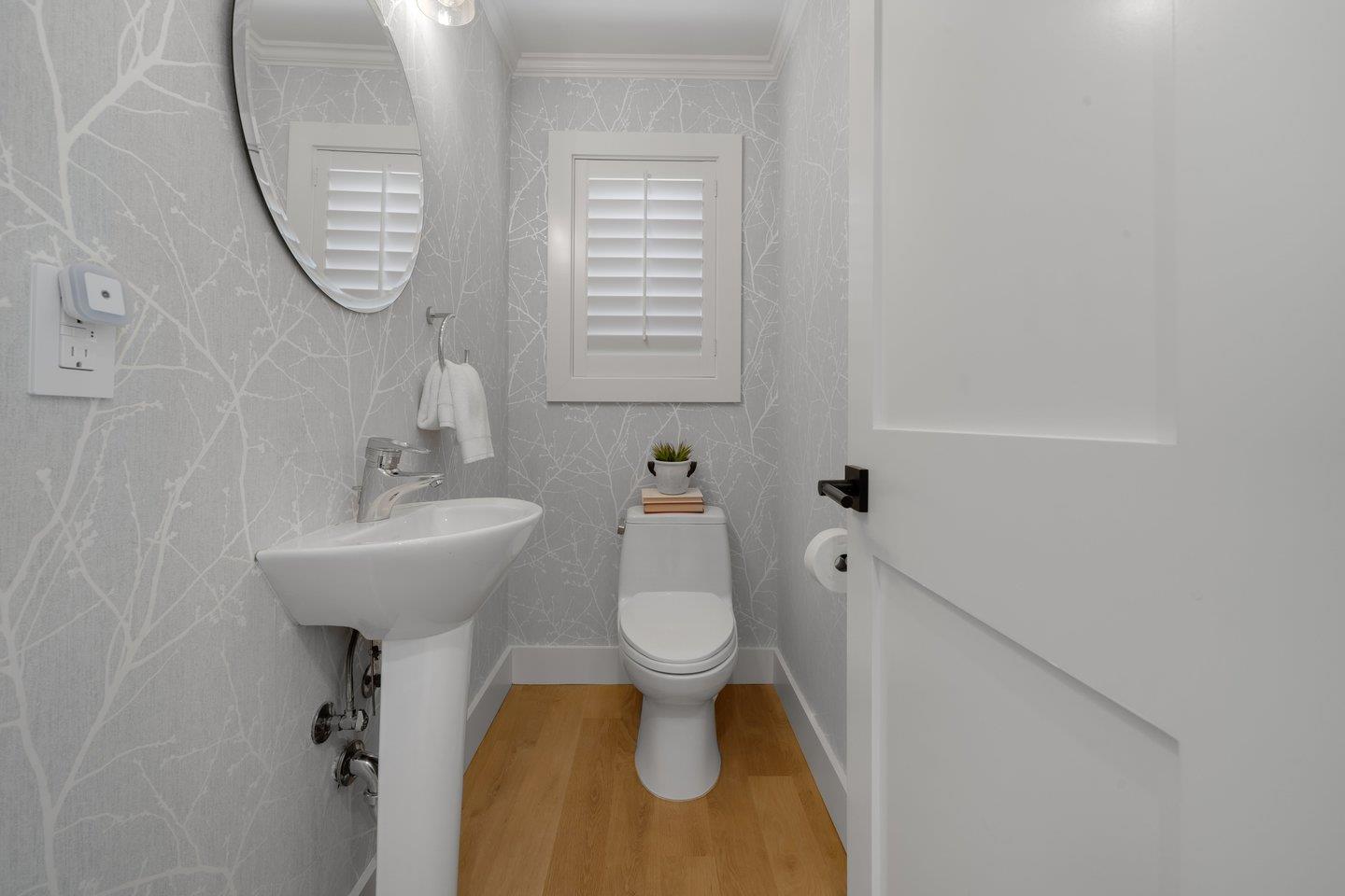 7 Del Monte Place San Mateo, CA 94403 - Photo 5 of 16 a bathroom with a toilet sink and mirror