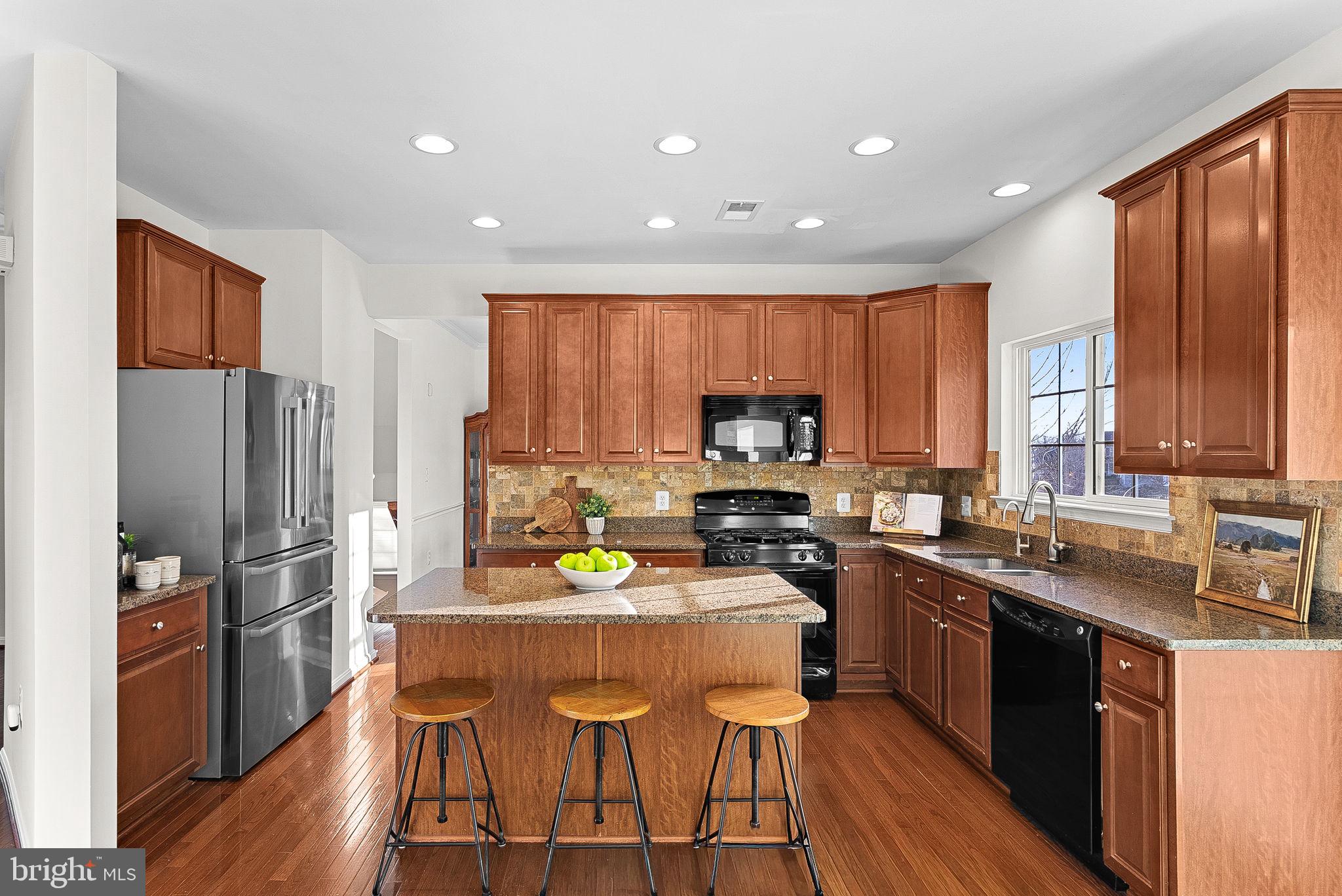 809 Devonshire Circle Purcellville, VA 20132 - Photo 12 of 36 a kitchen with stainless steel appliances a sink a stove a refrigerator cabinets and wooden floor